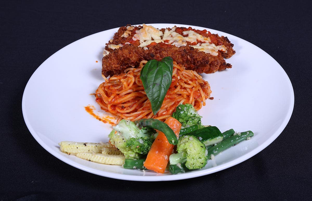 Breaded cutlet with pasta and vegetables at Foyer