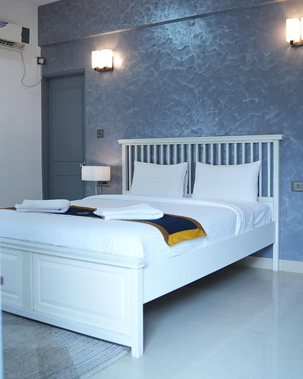 Serviced apartment bedroom with blue accent wall