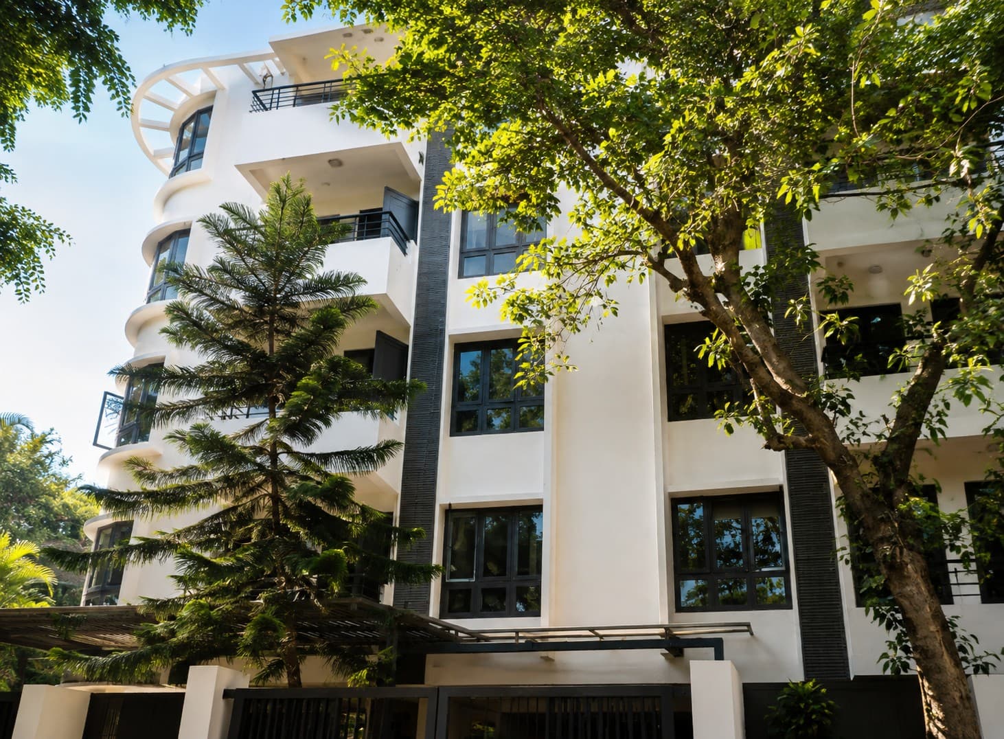 Regal Business Suites building exterior amid tree-lined Cooke Town, Bengaluru